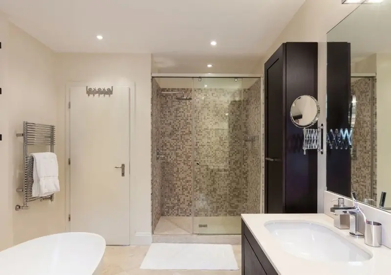 Renovated bathroom with a walk-in shower, freestanding bath and vanity