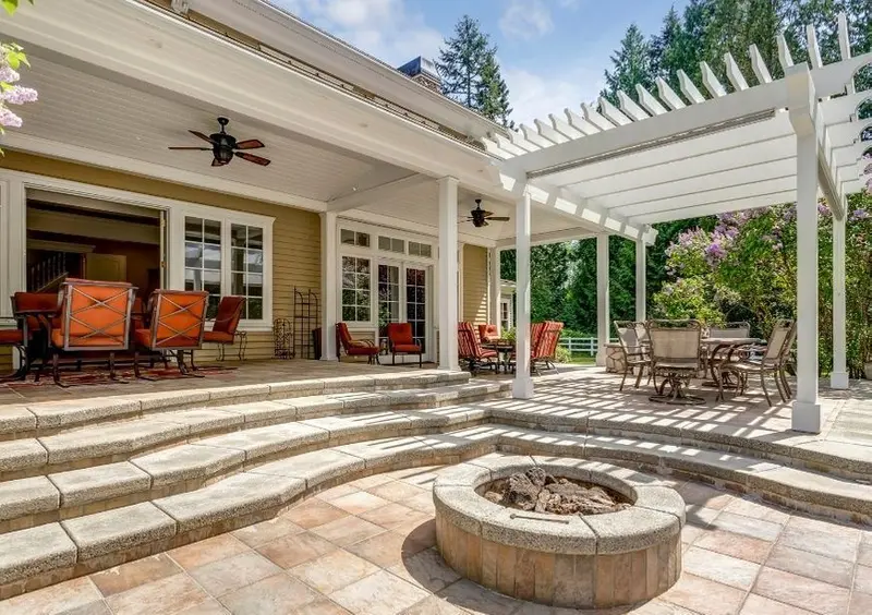 Covered patio with pergola, paved steps and a fire pit