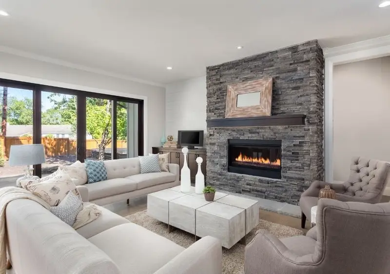 Renovated open-plan living room with a stone-clad fireplace